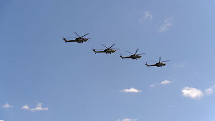 Image showing Combat helicopters Mi-28 fly in blue sky