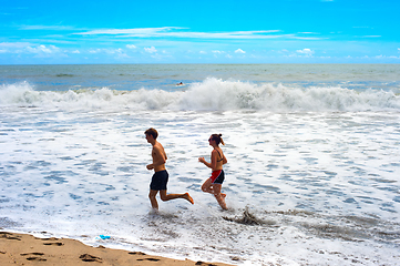 Image showing Couple running ocean beach Bali