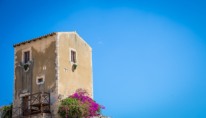 Image showing Sicily, Italy. Old house with purple flowers in Syracuse.