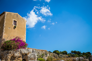 Image showing Sicily, Italy. Old house with purple flowers in Syracuse.