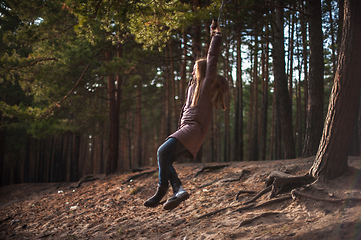 Image showing Woman at bungee in autumn forest