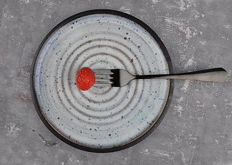 Image showing Strawberry on fork and plate