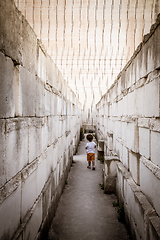 Image showing Lonely young boy walking in a corridor