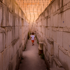 Image showing Lonely young boy walking in a corridor