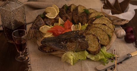 Image showing Stuffed pike with vegetables and greens.