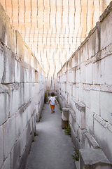 Image showing Lonely young boy walking in a corridor