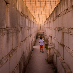 Image showing Lonely young boy walking in a corridor