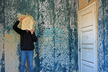 Image showing man with torn wallpaper