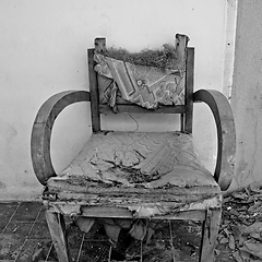 Image showing torn armchair and broken glass