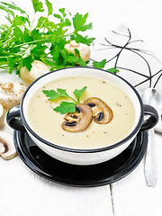 Image showing Soup puree of champignon in bowl on light board