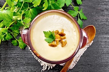 Image showing Soup puree of chanterelle in bowl on board top