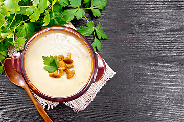 Image showing Soup puree of chanterelle in bowl on dark board top