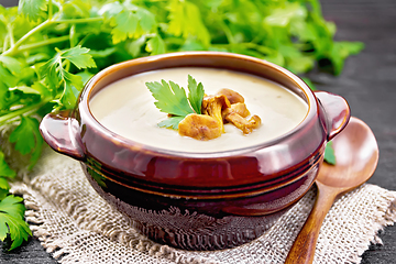 Image showing Soup puree of chanterelle in bowl on dark board