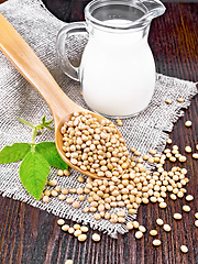 Image showing Soybeans in spoon with milk on wooden board