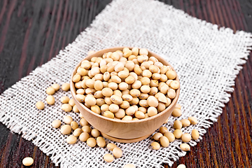 Image showing Soybeans in wooden bowl on dark board