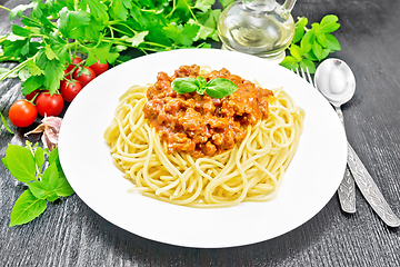 Image showing Spaghetti with bolognese on dark wooden board