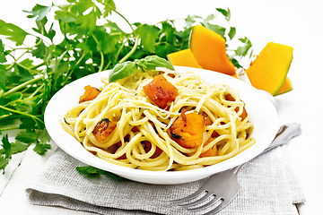 Image showing Spaghetti with pumpkin in plate on board