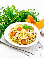 Image showing Spaghetti with pumpkin in plate on light wooden board