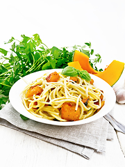 Image showing Spaghetti with pumpkin in plate on wooden board