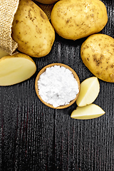 Image showing Starch potato in bowl on dark board top