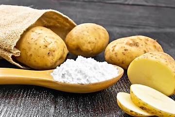 Image showing Starch potato in spoon on black board