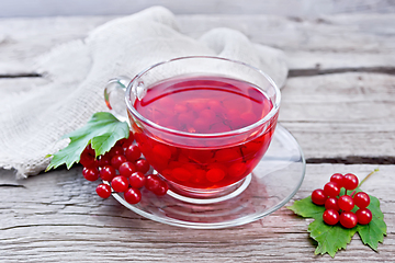 Image showing Tea from viburnum in cup with berries on gray board