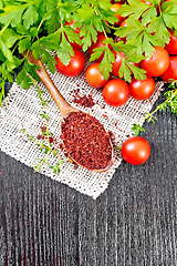 Image showing Tomatoes dried in spoon on wooden board top