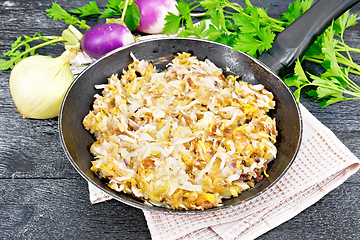 Image showing Turnip fried in pan on dark board