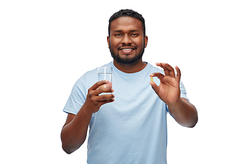 Image showing african american man with pill and glass of water