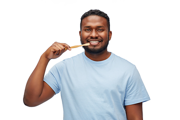 Image showing smiling african man with toothbrush cleaning teeth