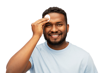 Image showing african american man cleaning face with cotton pad