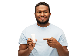 Image showing happy african american man showing moisturizer