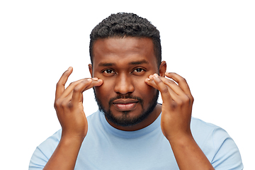 Image showing african american man touching his face