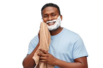 Image showing smiling african man with shaving cream and towel