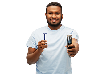 Image showing smiling african man with razor blade and trimmer