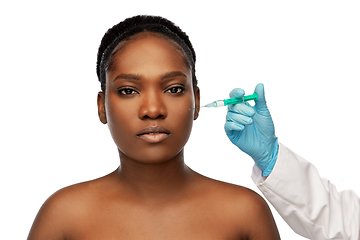 Image showing african woman and hand in glove with syringe