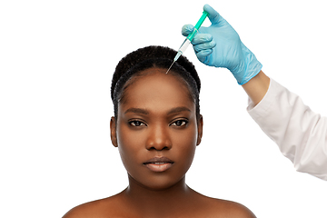 Image showing african woman and hand in glove with syringe