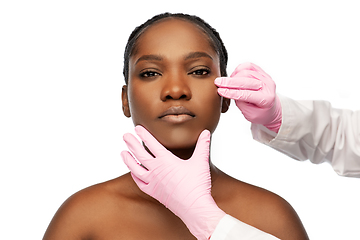 Image showing african american woman and hands in medical gloves