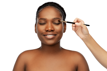 Image showing face of african woman and hand with make up brush