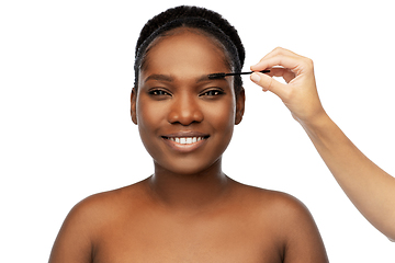 Image showing face of african woman and hand with mascara brush