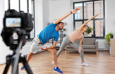 Image showing couple recording home yoga class video