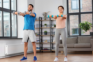 Image showing happy couple exercising at home