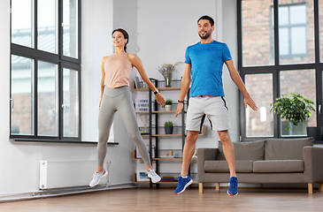 Image showing happy couple exercising at home