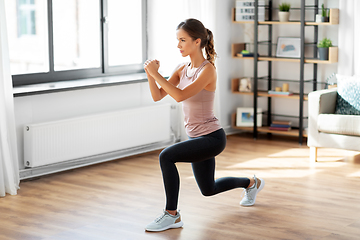 Image showing young woman exercising at home