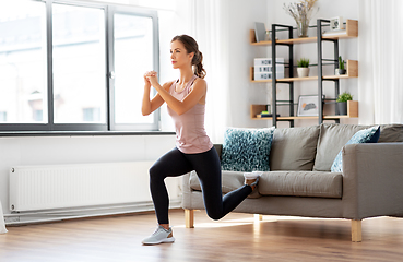 Image showing young woman exercising at home