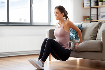 Image showing young woman exercising at home