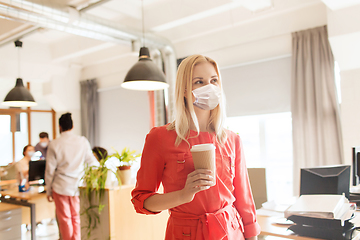 Image showing female office worker in mask with coffee cup