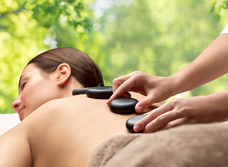 Image showing close up of woman having hot stone massage at spa