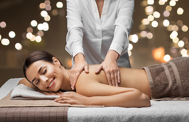 Image showing woman lying and having back massage at spa