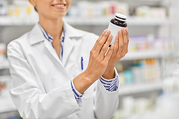 Image showing close up of pharmacist with medicine at pharmacy